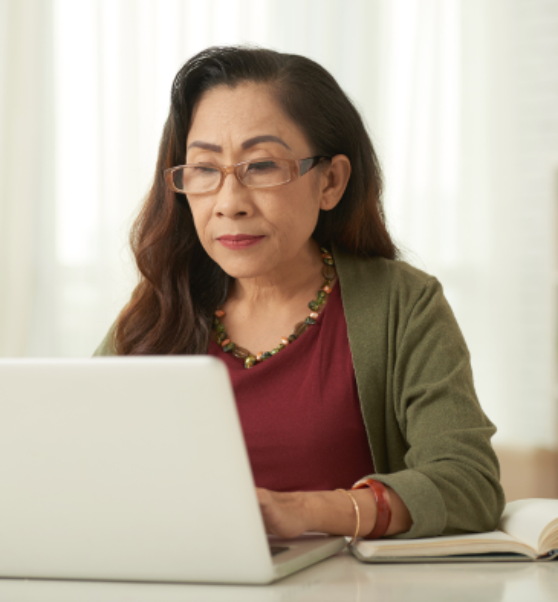 Older adult looking at a laptop.